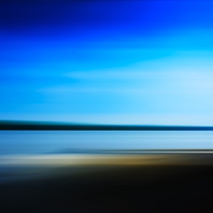 Distant seascape with blurred background and dark blue sky