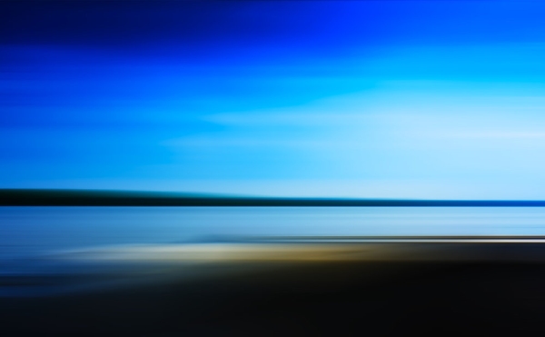 Distant seascape with blurred background and dark blue sky