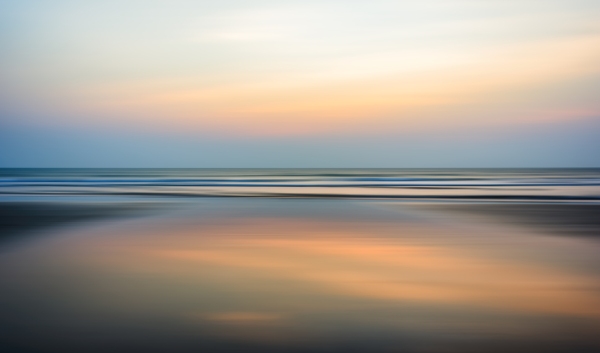 Blurred seascape with evening sunset background and distant horizon