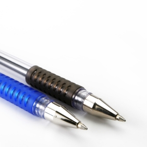 A close up macro view of two ballpoint pens