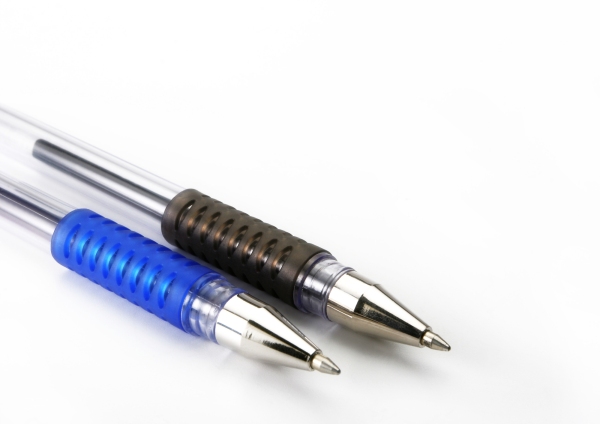 A close up macro view of two ballpoint pens