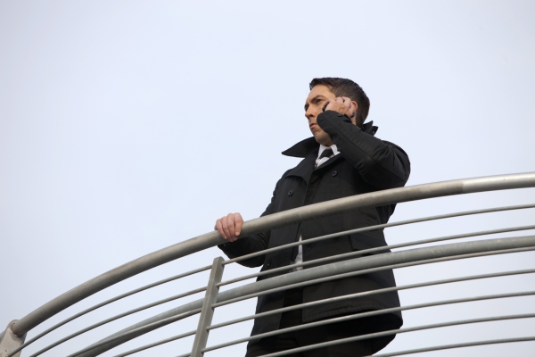 A security guard scanning the area from a high vantage point