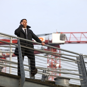 Security guard on a building site with a large crane in the background