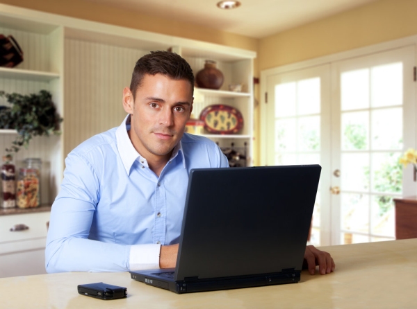 Man working at laptop computer from home