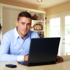 Man working at laptop computer from home