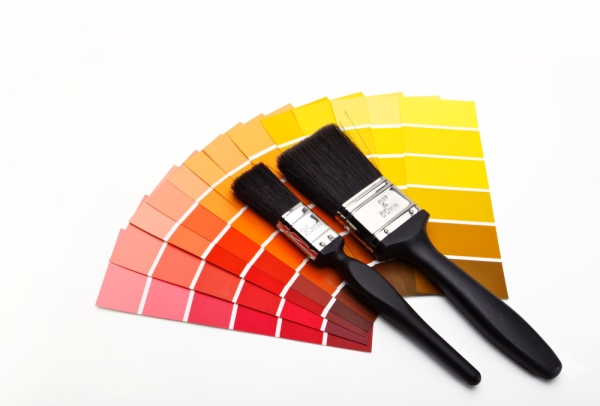 Paint brushes with red, yellow, orange and brown colour swatches