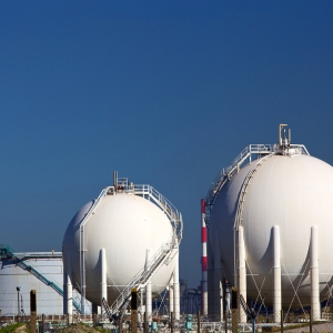 White chemical storage tanks at a petrochemicals manufacturing plant