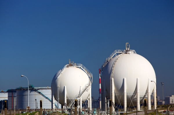 White chemical storage tanks at a petrochemicals manufacturing plant