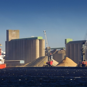 A ship loading or unloading at a heavy industry dock area