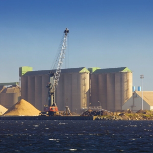 Dockside silos and cranes for import and export of raw materials and resources