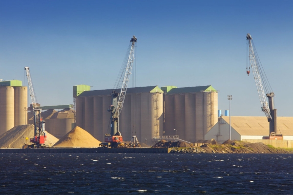 Dockside silos and cranes for import and export of raw materials and resources