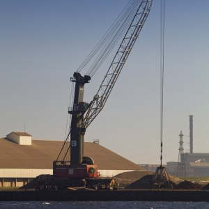 A dockside crane in a heavily industrialised dockland area