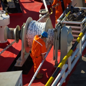 A deckhand securing mooring and anchor ropes on a North Sea Ferry