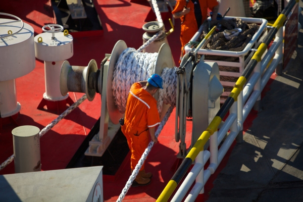 A deckhand securing mooring and anchor ropes on a North Sea Ferry