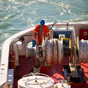 A deckhand on a North Sea Ferry at work securing cables