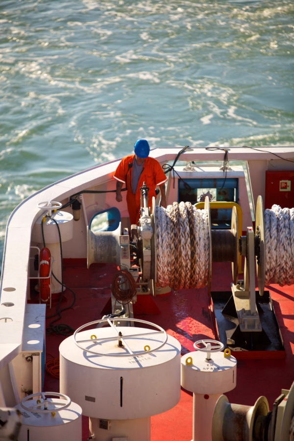 A deckhand on a North Sea Ferry at work securing cables