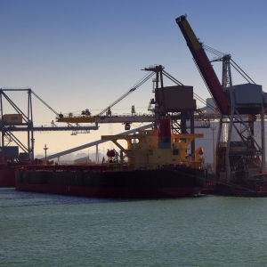 Cargo ships and tankers loading and unloading their cargos at an industrial port