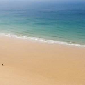 Wide golden sands and clear blue water at Watergate Bay in Cornwall