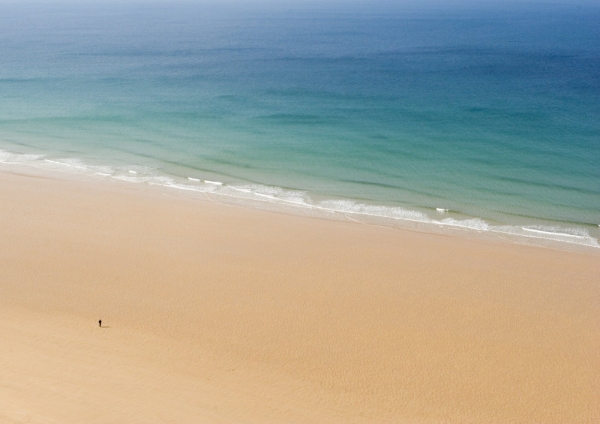 Wide golden sands and clear blue water at Watergate Bay in Cornwall