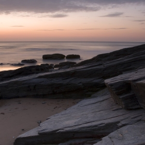 Sunset on a rocky shore in Cornwall