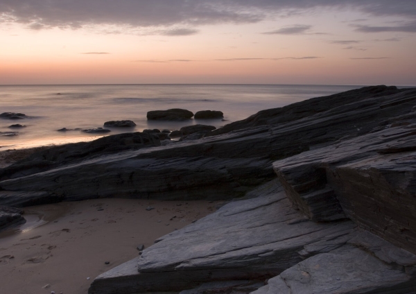 Sunset on a rocky shore in Cornwall