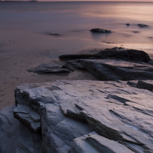 Orange sunset on a rocky shore