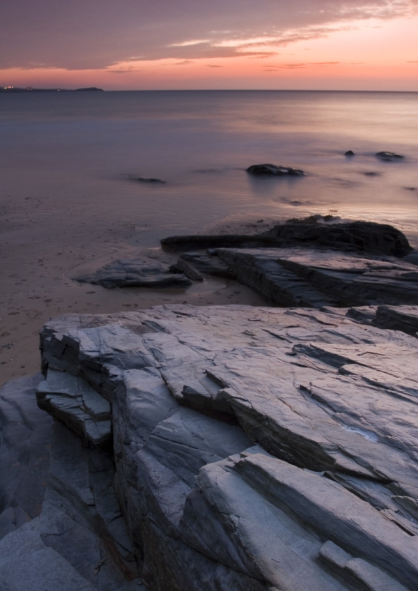 Orange sunset on a rocky shore