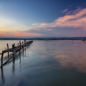 Long exposure landscape with old broken pier with reflection