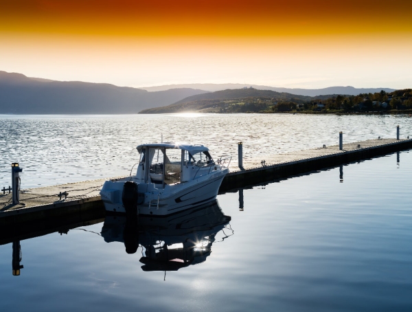 A small boat moored at a pier in Norwegian fiords