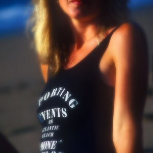 pretty young woman on on the beach, looking at camera