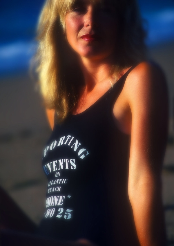 pretty young woman on on the beach, looking at camera