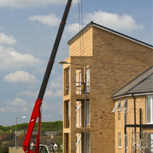 A heavy lift crane with caterpillar tracks on a building site