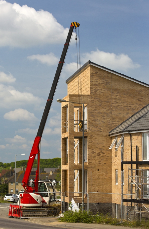 A heavy lift crane with caterpillar tracks on a building site