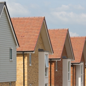 Roofs of new houses in a row with blue sky