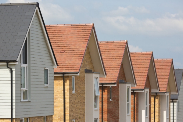 Roofs of new houses in a row with blue sky