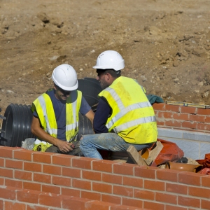 Two construction workers on a building site