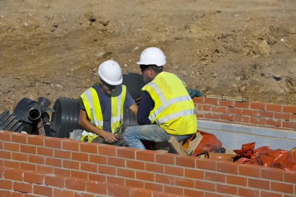 Two construction workers on a building site