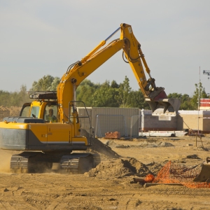 A large 360 digger on a modern housing development