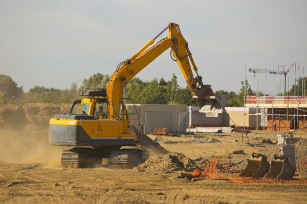 A large 360 digger on a modern housing development