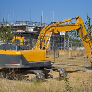 A digger or earth mover with caterpillar tracks on a building site