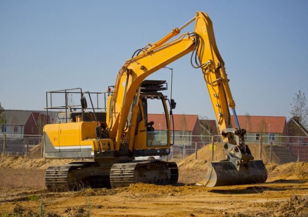 A digger or earth mover with caterpillar tracks on a building site