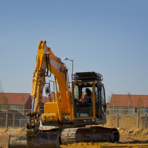 Digger or earth mover or backhoe working on a construction or building site