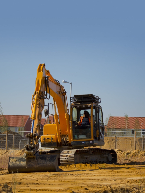 Digger or earth mover or backhoe working on a construction or building site