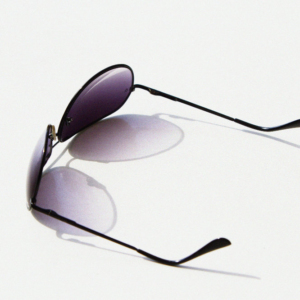 Aviator style sunglasses on a white table top