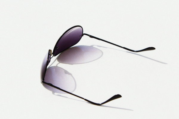 Aviator style sunglasses on a white table top