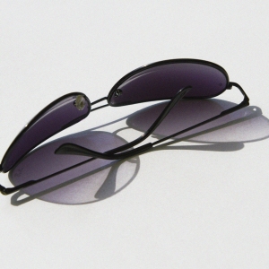 a pair of aviator style sunglass on a table top