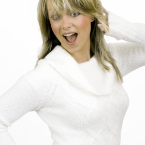 A pretty blonde girl having fun, white background