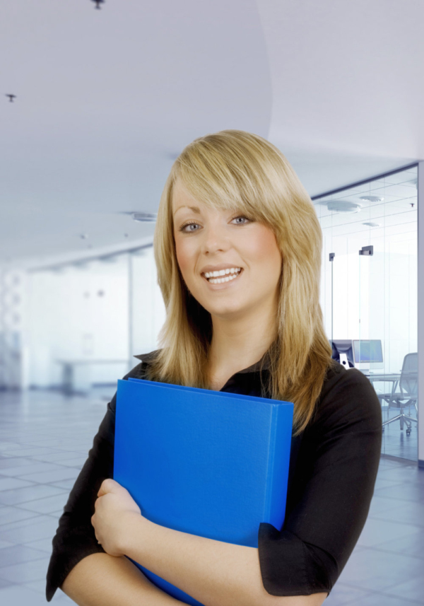 Pretty young office worker with blue folder and blurred background