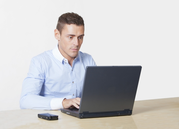 handsome young man working on a laptop computer