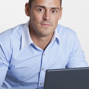 Man at computer looking directly into camera